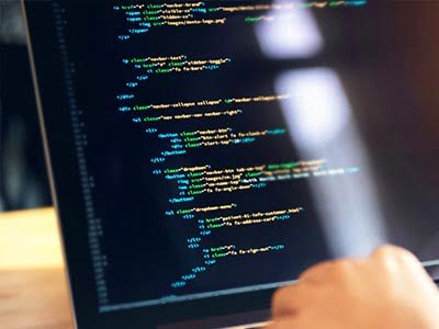 computer with split screen showing a user developing a website at a digital marketing agency