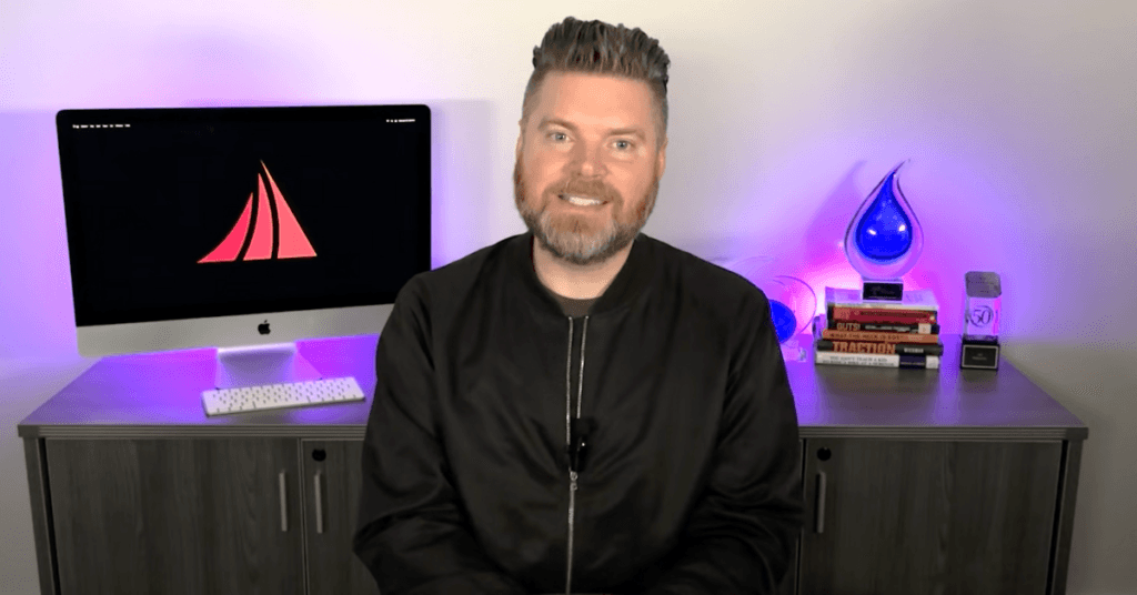 Mediaura's CEO, Andrew Aebersold, sits in front of a desk, explaining Ask Engine Optimization, the new way to optimize your site for AI Search.